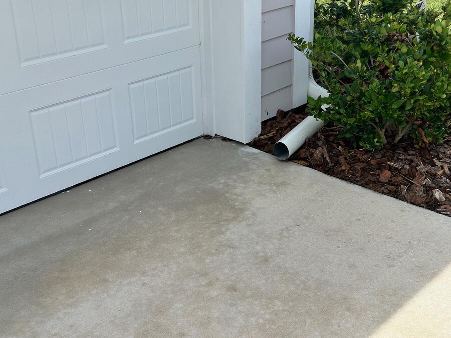 Concrete driveway pressure washing after, evenly cleaned light grey surface, Windermere FL